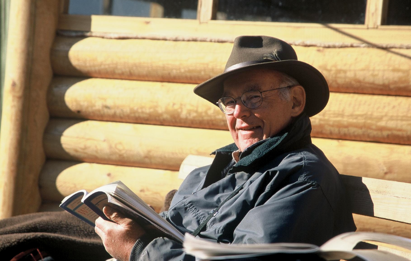 Gordon smiling with his hat on reading a book Gordon smiling with his hat on reading a book